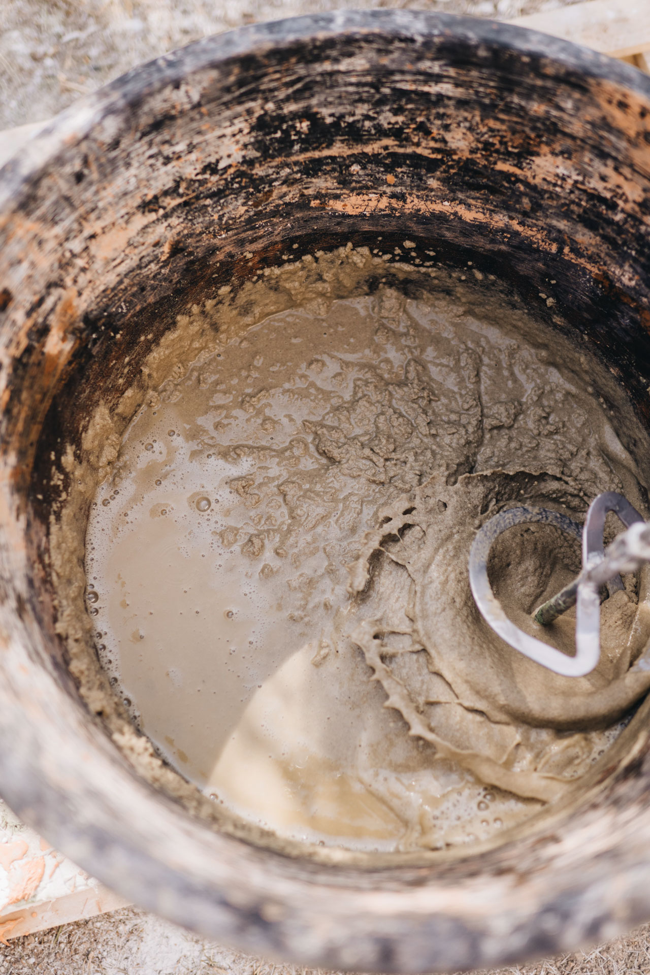 Mixing concrete in a bucket