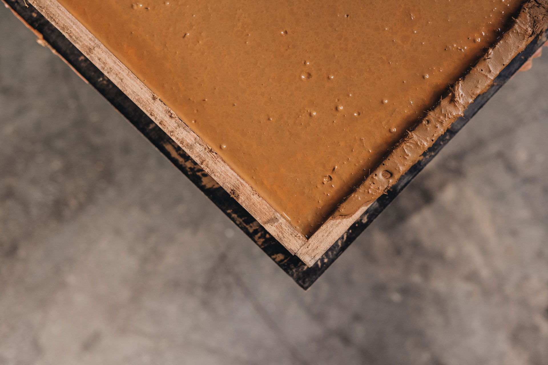 Brown mixture in wooden container